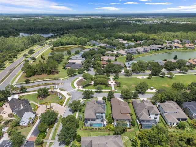 birds eye view of property featuring a water view, a residential view, and a view of trees