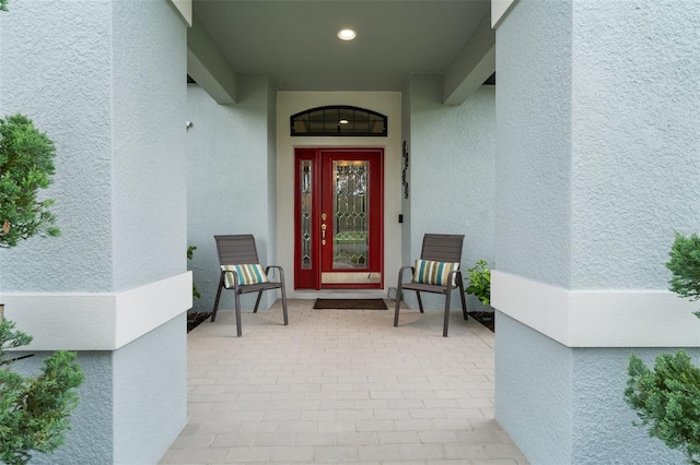 view of exterior entry with stucco siding