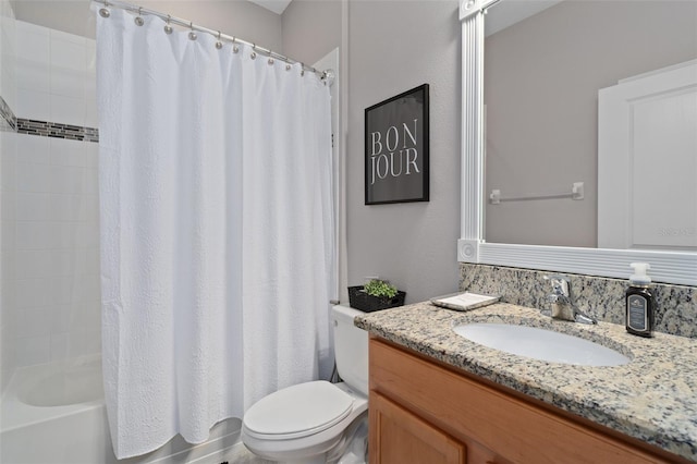 bathroom with shower / bathtub combination with curtain, vanity, and toilet