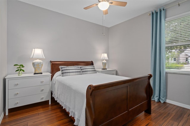 bedroom with hardwood / wood-style floors, a ceiling fan, and baseboards