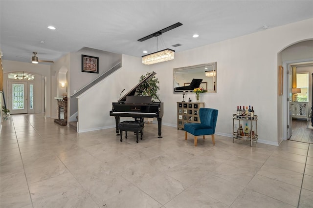 living area with plenty of natural light, arched walkways, baseboards, and recessed lighting