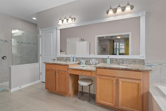 bathroom with a tub, double vanity, a sink, and walk in shower