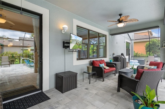 sunroom with ceiling fan