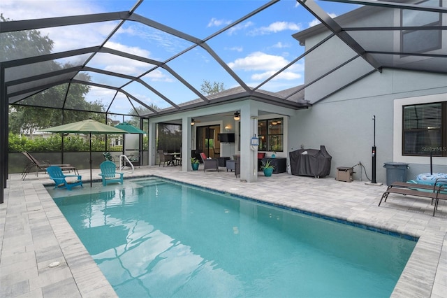 pool with glass enclosure and a patio area