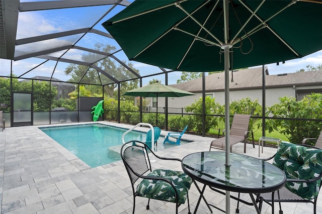 view of swimming pool with a patio, a lanai, and a fenced in pool