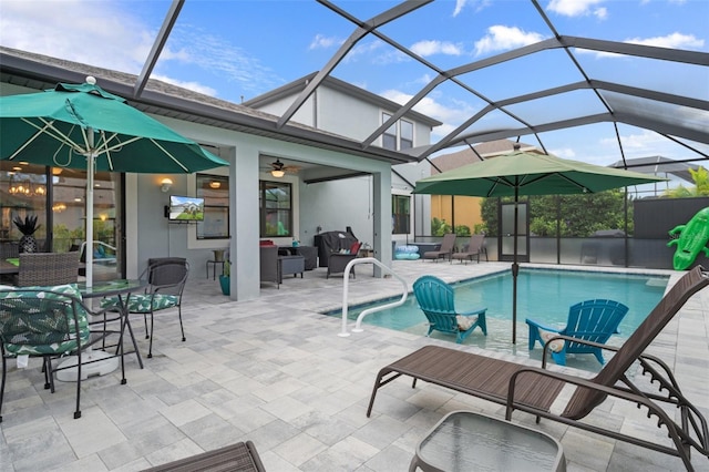 pool featuring a patio, glass enclosure, and a ceiling fan