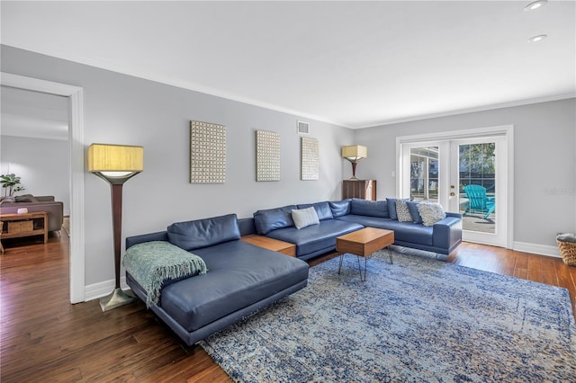 living area with baseboards, ornamental molding, wood finished floors, and french doors