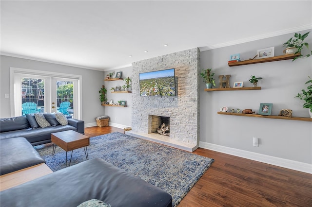 living area with crown molding, french doors, a fireplace, and wood finished floors