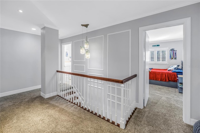 hall with carpet floors, recessed lighting, ornamental molding, and baseboards