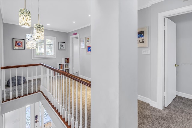 corridor featuring recessed lighting, crown molding, baseboards, carpet, and an inviting chandelier