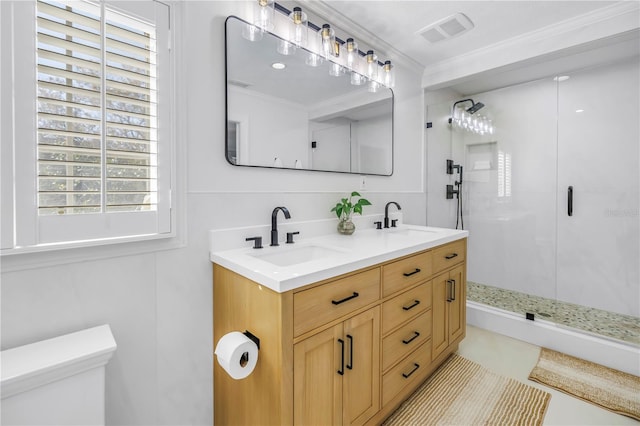 full bathroom featuring ornamental molding, a stall shower, visible vents, and a sink