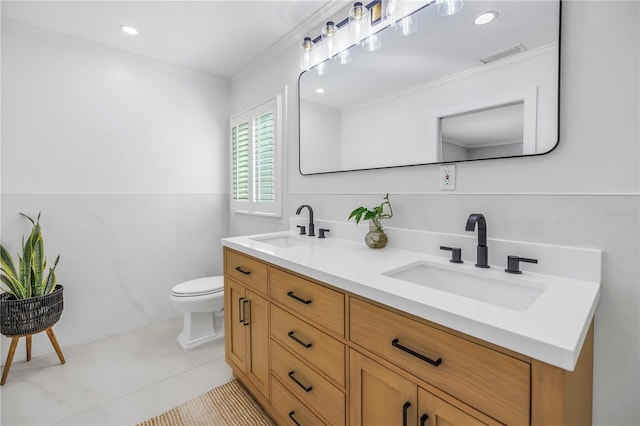 full bath featuring visible vents, a sink, toilet, and double vanity