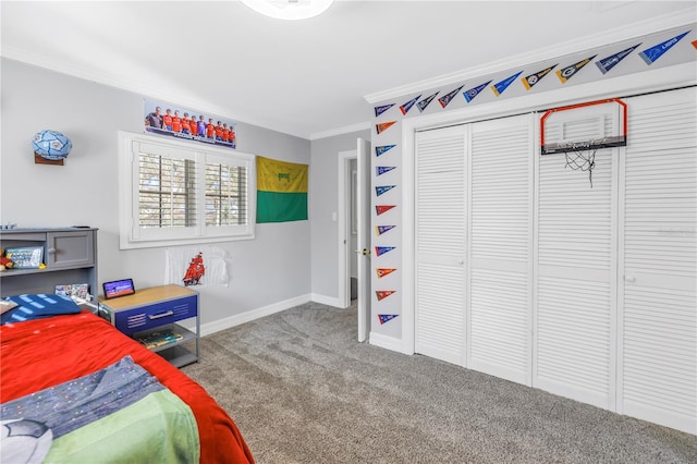 carpeted bedroom with baseboards, a closet, and crown molding