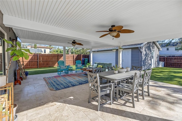 view of patio with outdoor dining space, a fenced backyard, ceiling fan, and an outdoor structure