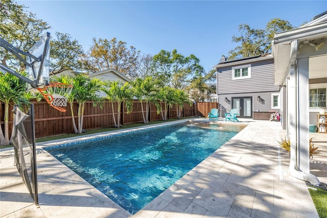 view of pool featuring a fenced backyard, a fenced in pool, a patio, and french doors