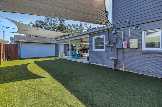 view of yard with a patio area, an outdoor structure, and fence