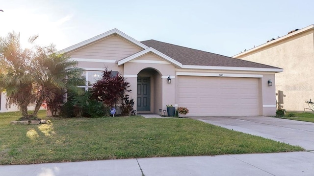 view of front facade featuring a garage, driveway, a front lawn, and stucco siding