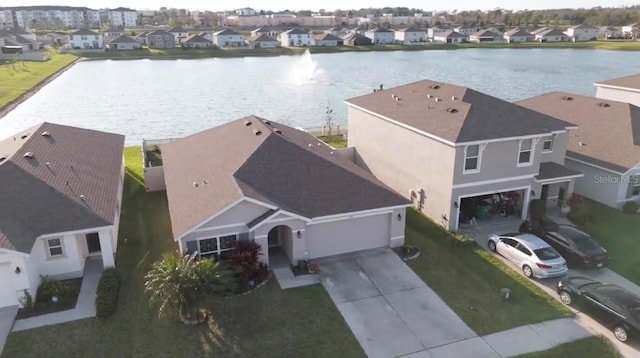 bird's eye view featuring a water view and a residential view