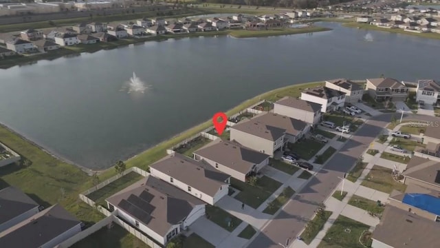 drone / aerial view featuring a residential view and a water view