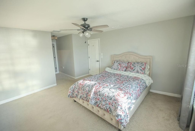 bedroom with a ceiling fan, carpet flooring, and baseboards