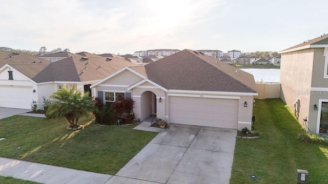 single story home featuring stucco siding, an attached garage, a residential view, driveway, and a front lawn