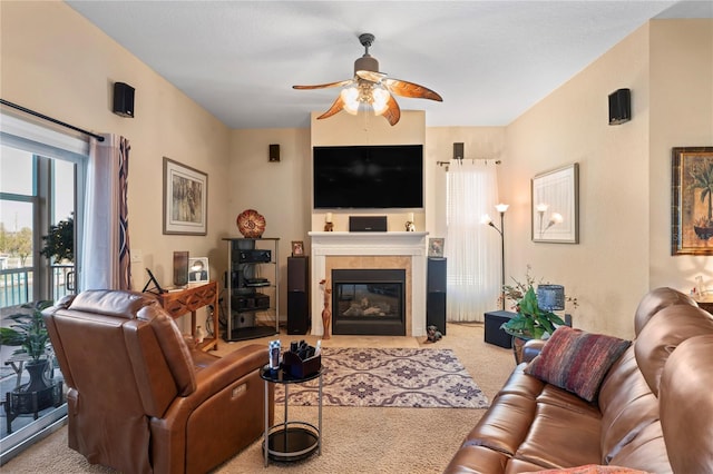 living room featuring ceiling fan, a fireplace, and carpet flooring