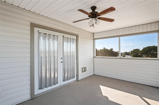 unfurnished sunroom featuring ceiling fan