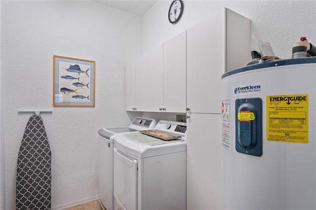 clothes washing area featuring water heater, a textured wall, cabinet space, and washer and dryer