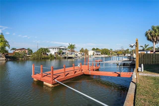 dock area with a water view and fence