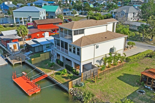 drone / aerial view with a water view and a residential view