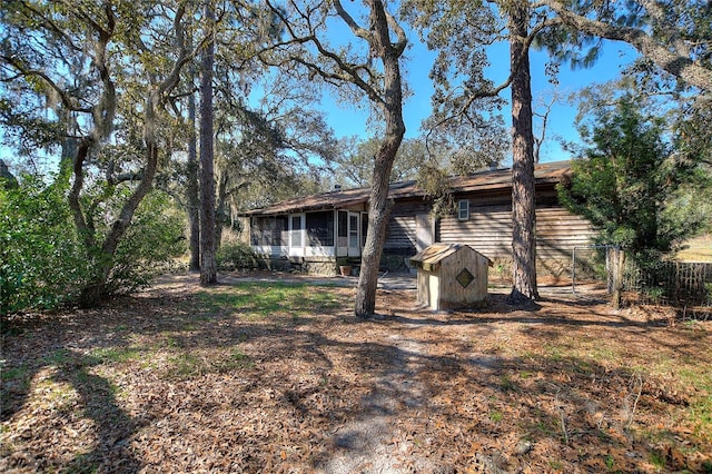 back of house featuring a sunroom