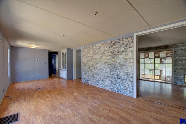 spare room featuring visible vents and wood finished floors