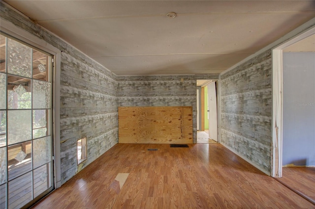 spare room featuring wood finished floors