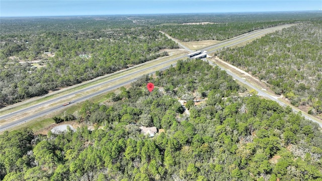 birds eye view of property featuring a wooded view