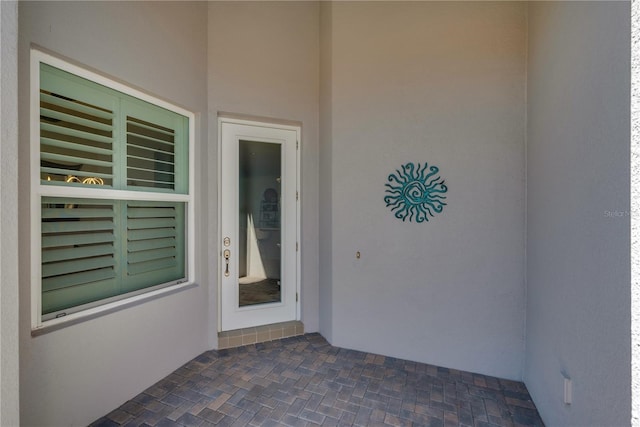 property entrance with stucco siding