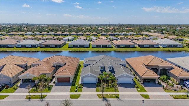 bird's eye view featuring a water view and a residential view