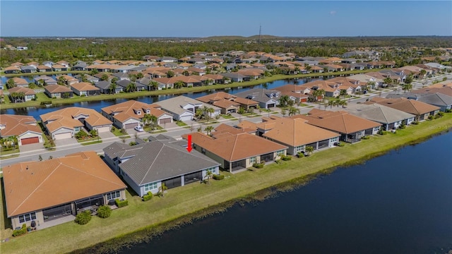 drone / aerial view with a residential view and a water view