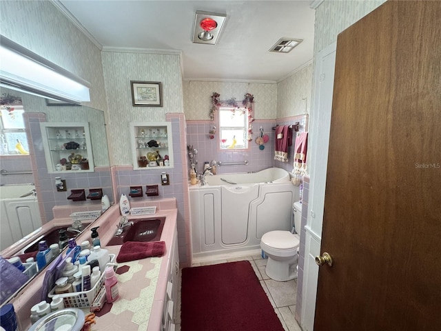 bathroom with wallpapered walls, visible vents, a bath, tile patterned floors, and tile walls