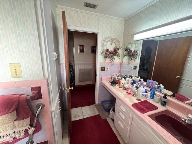 bathroom featuring wallpapered walls, visible vents, tile patterned flooring, crown molding, and vanity