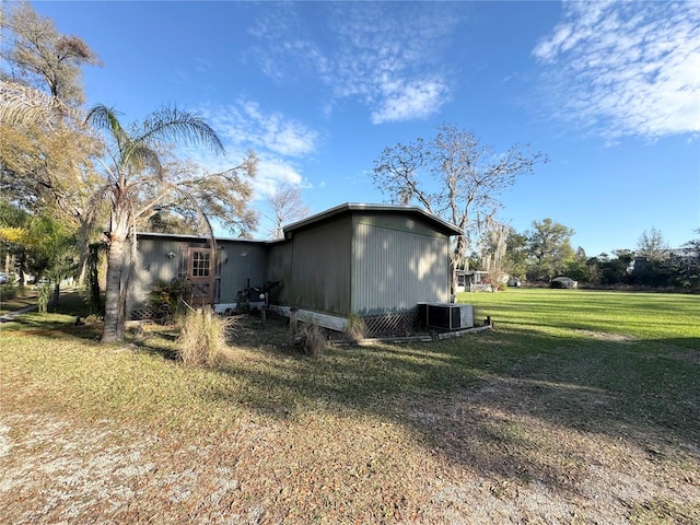 view of home's exterior featuring a lawn and central air condition unit