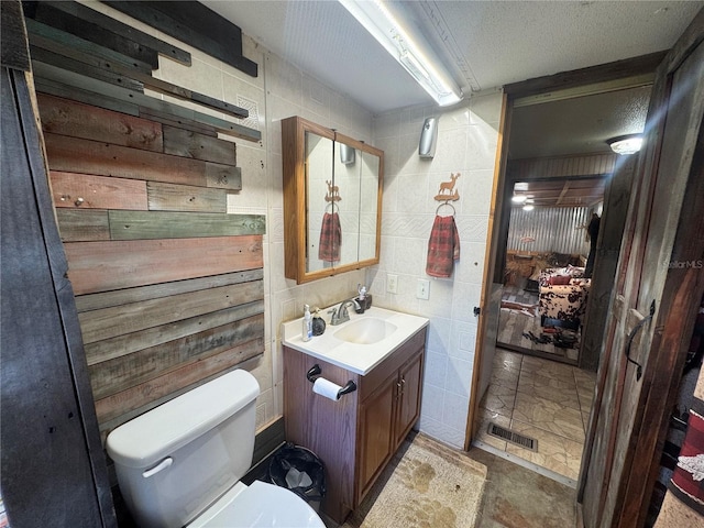 bathroom featuring visible vents, vanity, and toilet