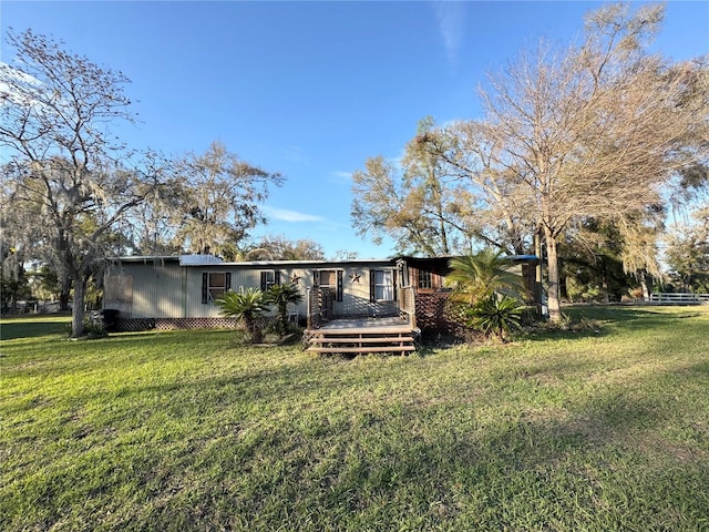 back of house with a yard and a wooden deck