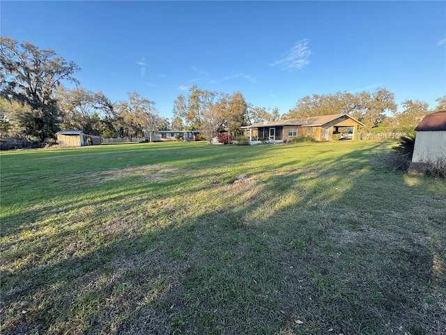 view of yard with a shed and an outbuilding