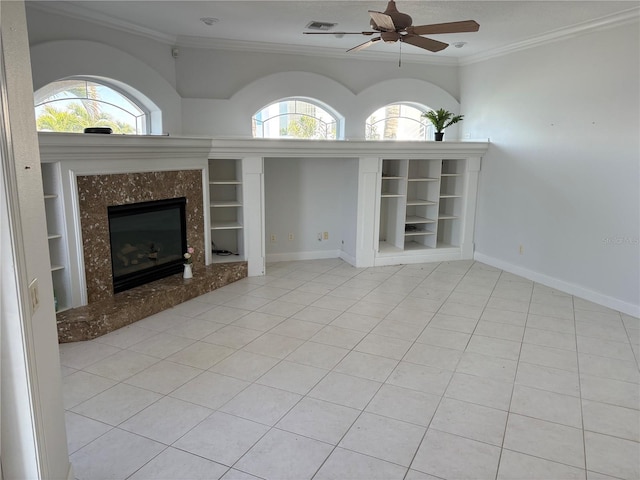 unfurnished living room with baseboards, a premium fireplace, ornamental molding, and built in features