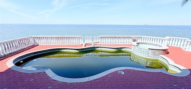 view of pool featuring a water view