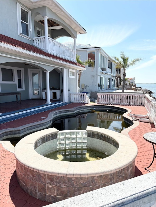 view of swimming pool with an in ground hot tub