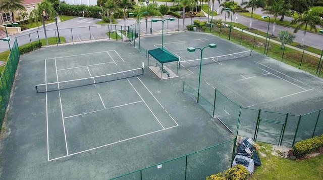 view of tennis court featuring fence