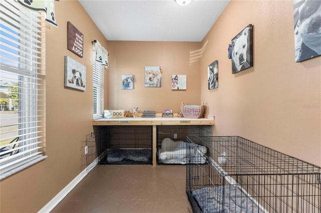 interior space featuring finished concrete flooring and baseboards