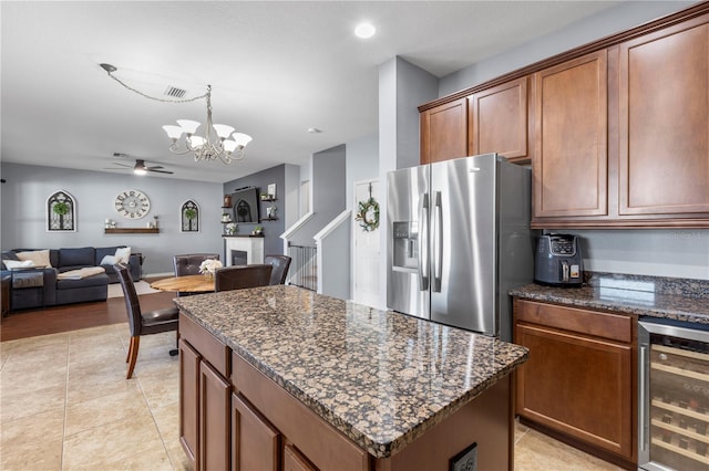 kitchen with a center island, wine cooler, visible vents, open floor plan, and stainless steel fridge