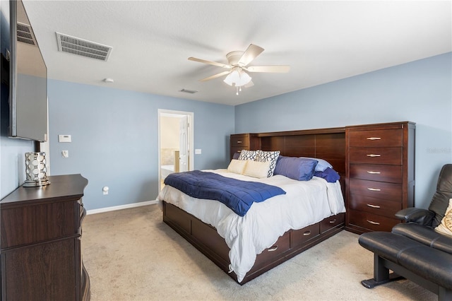 bedroom with baseboards, visible vents, and light colored carpet